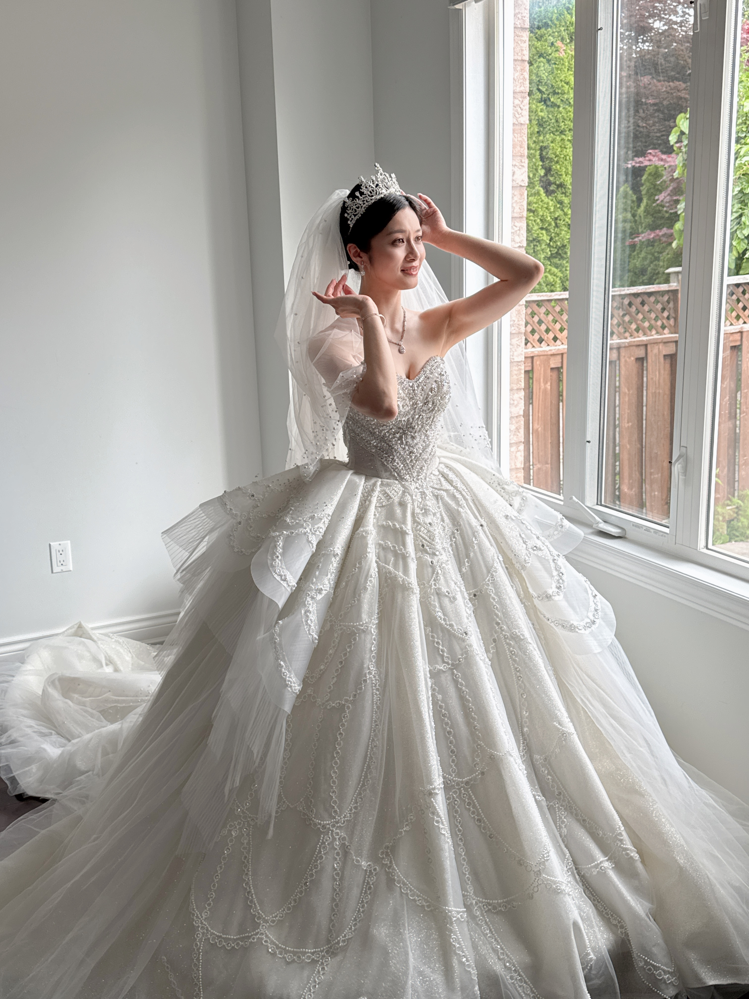 Asian bride in Toronto wearing a white ball gown with elegant bridal makeup 