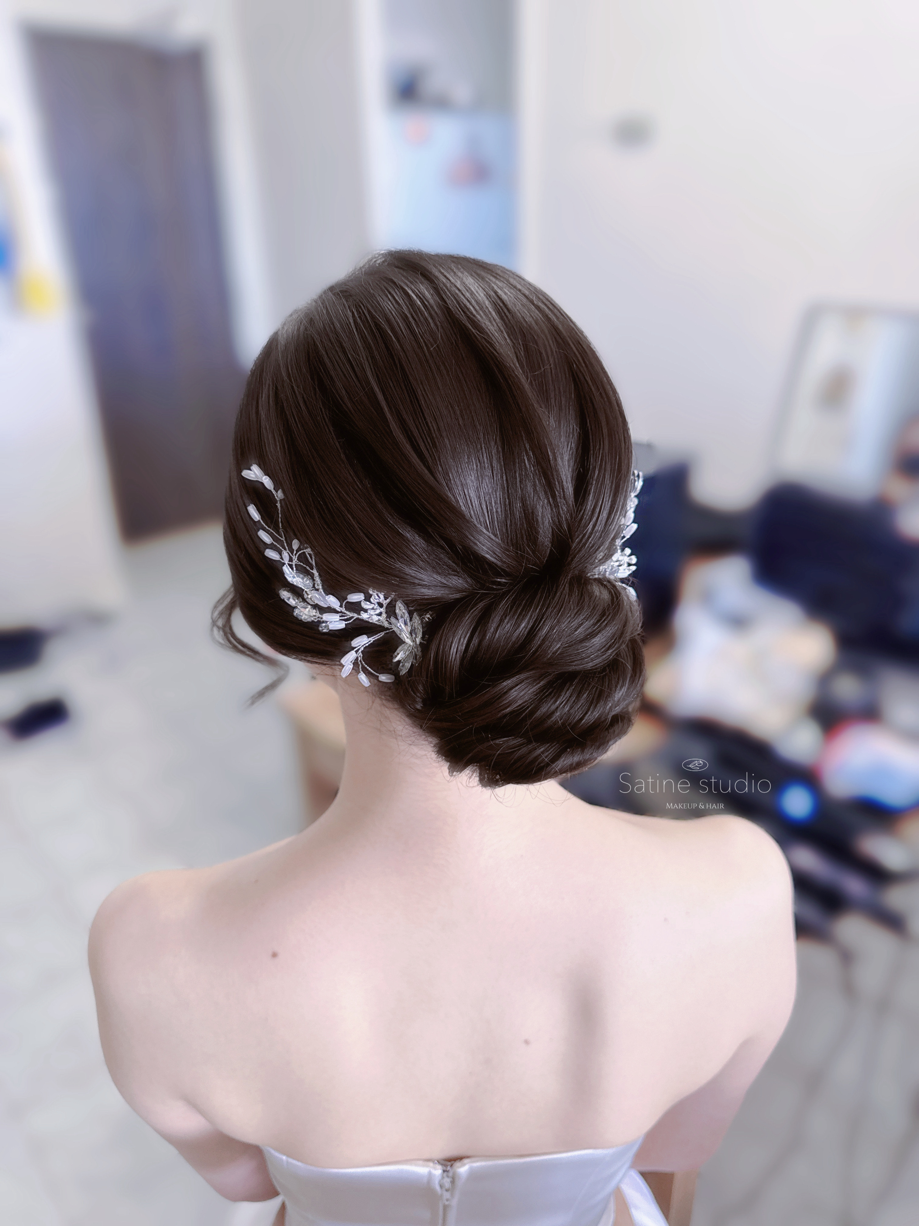 Romantic low bun bridal hairstyle in Toronto-elegant wedding updo with handmade accessory by Satine Studio. 