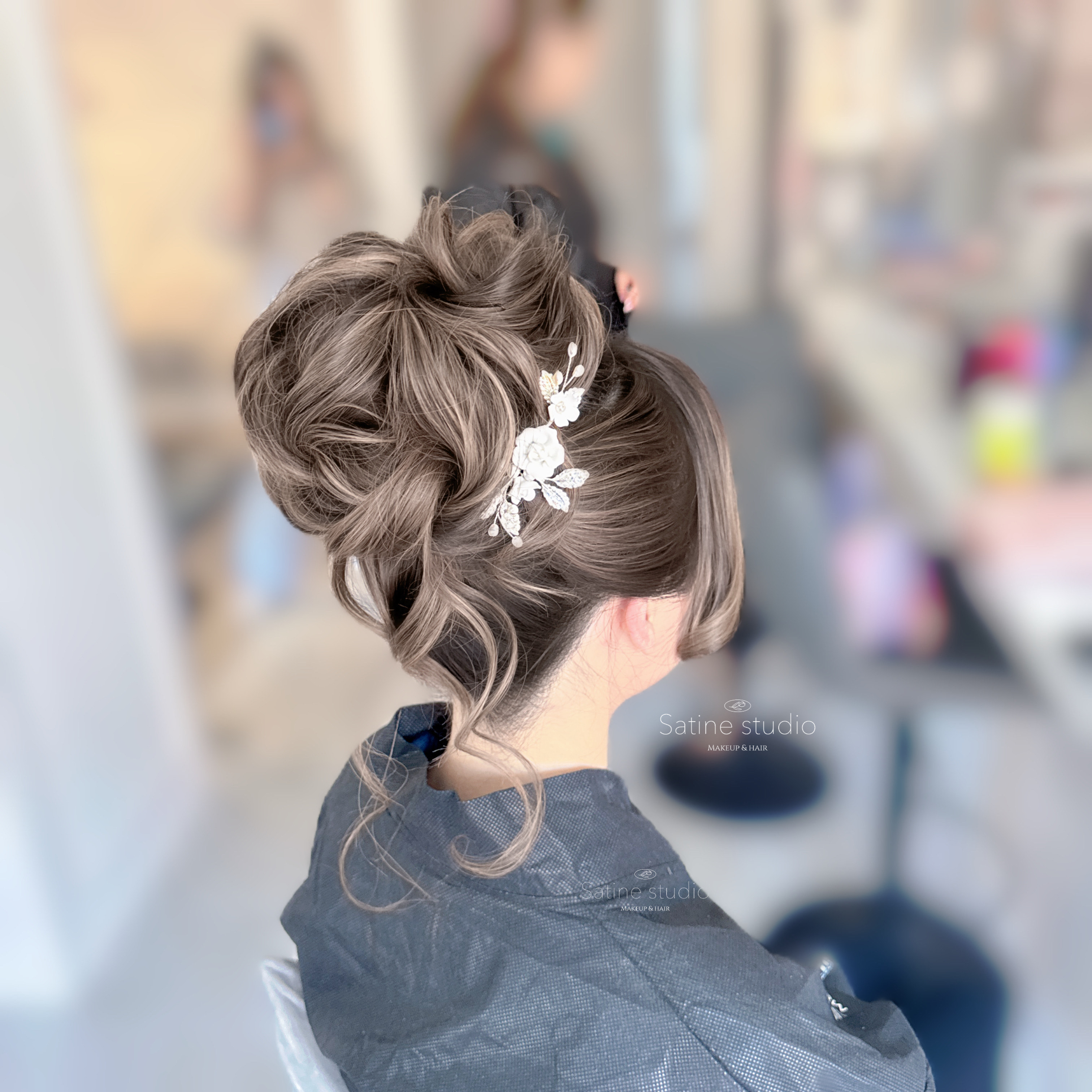 Soft high bun bridal hair style in Toronto-Chic and modern wedding updo by Satine Studio.