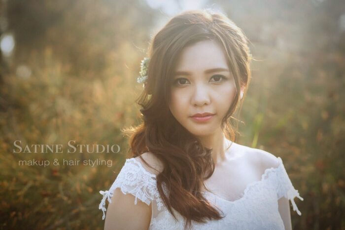 Close-up of Asian bridal makeup with romantic loose hairstyle in Toronto by Satine Yang